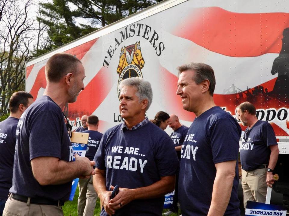 Teamsters Local Union 8 President Jon Light (left) talks with state house representatives Scott Conklin (center) and Paul Takac during a rally before they began negotiations with Penn State on May 2. Halie Kines/hkines@centredaily.com