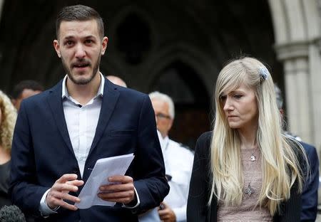 Charlie Gard's parents Connie Yates and Chris Gard read a statement at the High Court after a hearing on their baby's future, in London, Britain July 24, 2017. REUTERS/Peter Nicholls