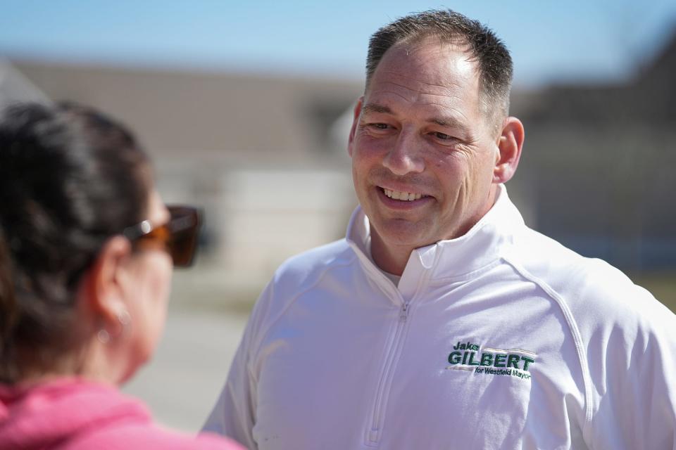Jake Gilbert, a candidate for Westfield Mayor, talks to someone while out canvassing neighborhoods on Wednesday, March 15, 2023. Gilbert is a current city council member and head coach of the high school football team. 