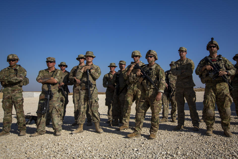 FILE - In this Monday, Nov. 11, 2019, file photo, crewmen of Bradley fighting vehicles stand guard at a U.S. military base in Northeastern Syria. Iran has had its fingers in Iraq's politics for years, but the U.S. killing of an Iranian general and Iraqi militia commander outside Baghdad has added new impetus to the effort, stoking anti-Americanism that Tehran now hopes it can exploit to help realize the goal of getting U.S. troops out of the country. (AP Photo/Darko Bandic, File)