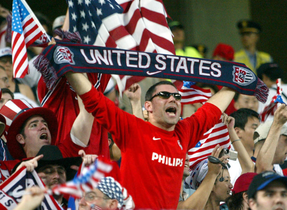 A U.S. soccer fan holds a team scarf as he celebrates with other fans
after they won against Portugal in their group D World Cup Finals match
in Suwon, June 5, 2002. The USA recorded their greatest soccer victory
in over half a century when they upset fancied Portugal 3-2 in their
World Cup opening group D clash on Wednesday. REUTERS/Shaun Best

JES/JP