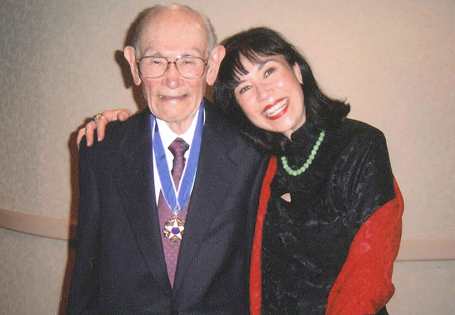 Karen Korematsu poses with her father, the late civil rights icon Fred Korematsu, after he was awarded the Presidential Medal of Freedom from then-President Bill Clinton in 1998. (Photo by Shirley Nakao, courtesy of the Fred T. Korematsu Institute)