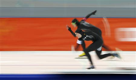 Heather Richardson of the U.S. and Lauren Cholewinski of the U.S. skate during the women's 500 metres speed skating race at the Adler Arena during the 2014 Sochi Winter Olympics February 11, 2014. REUTERS/Marko Djurica