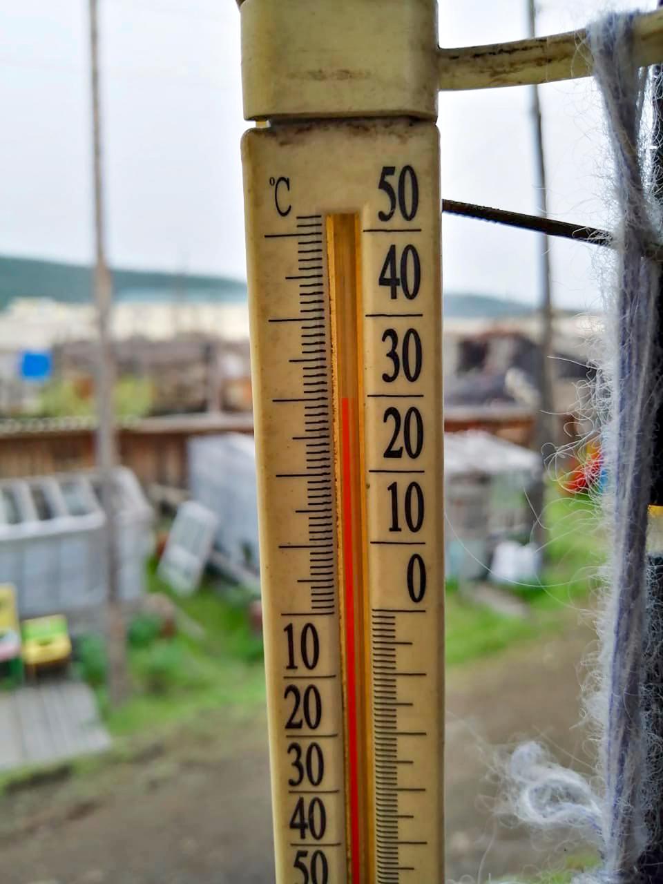 FILE - This Sunday, June 21, 2020 photo provided by Olga Burtseva shows an outdoor thermometer indicating 30 Celsius (86 Fahrenheit) around 11 p.m in Verkhoyansk, Sakha Republic, about 4,660 kilometers (2,900 miles) northeast of Moscow, Russia. A record-breaking temperature of 38 degrees Celsius (100.4 degrees Fahrenheit) was registered in the Arctic town the previous day in a prolonged heatwave that has alarmed scientists around the world. (Olga Burtseva via AP)