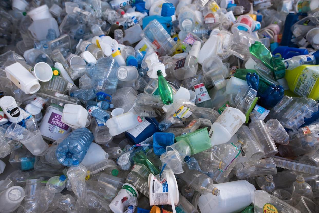 Part of the 'Turn Off The Plastic Tap' art installation by Benjamin Von Wong is photographed on its final day outside Ripley's Aquarium of Canada in Toronto on Monday, June 20, 2022. The government has began phasing out six harmful plastics as part of the plan to ban single-use plastic.  (Tijana Martin/The Canadian Press - image credit)