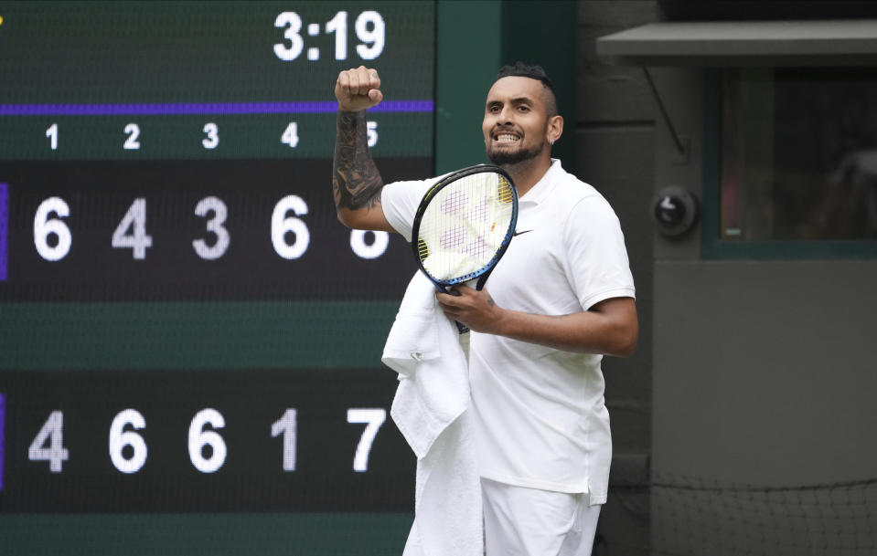 Australia's Nick Kyrgios celebrates winning the men's singles first round match against Ugo Humbert of France on day three of the Wimbledon Tennis Championships in London, Wednesday June 30, 2021. (AP Photo/Alberto Pezzali)