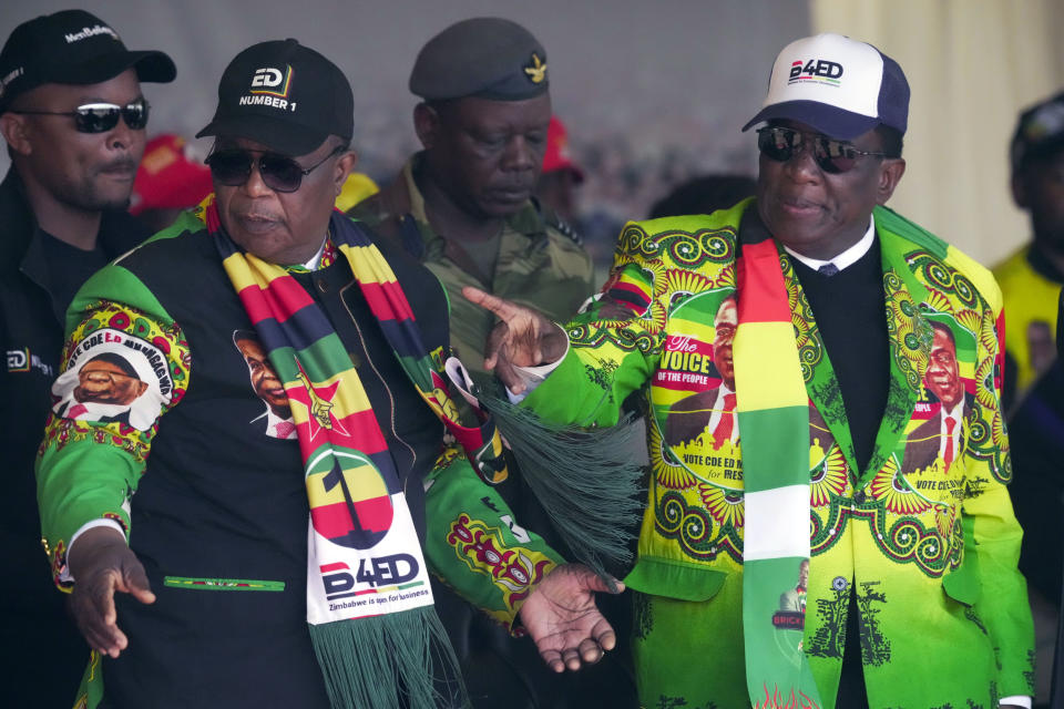 Zimbabwean President Emmerson Mnangagwa, left, is seen with his deputy Constantino Chiwenga at a campaign rally in Harare, Wednesday, Aug. 9, 2023. Mnangagwa addressed thousands of supporters in a speech laden with calls for peace, days after his supporters were accused of stoning an opposition activist to death ahead of general elections set for Aug. 23. (AP Photo/Tsvangirayi Mukwazhi)