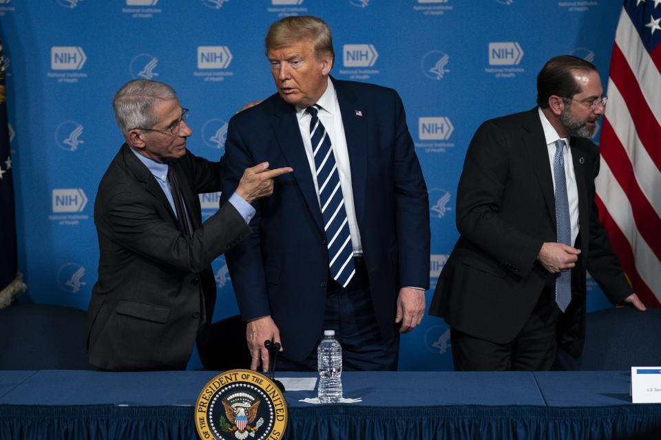 Dr. Anthony Fauci, director of the National Institute of Allergy and Infectious Diseases, left, President Donald Trump, center, and Secretary of Health and Human Services Alex Azar leave a briefing on the coronavirus at the National Institutes of Health, Tuesday, March 3, 2020, in Bethesda, Md. (AP Photo/Evan Vucci)