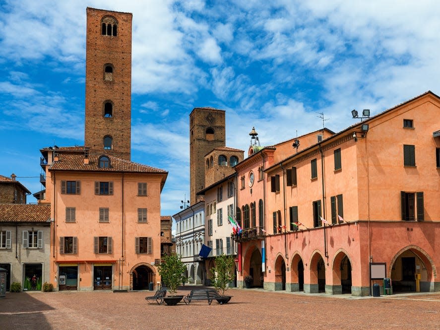 Colorful buildings surround a cobblestone town square.