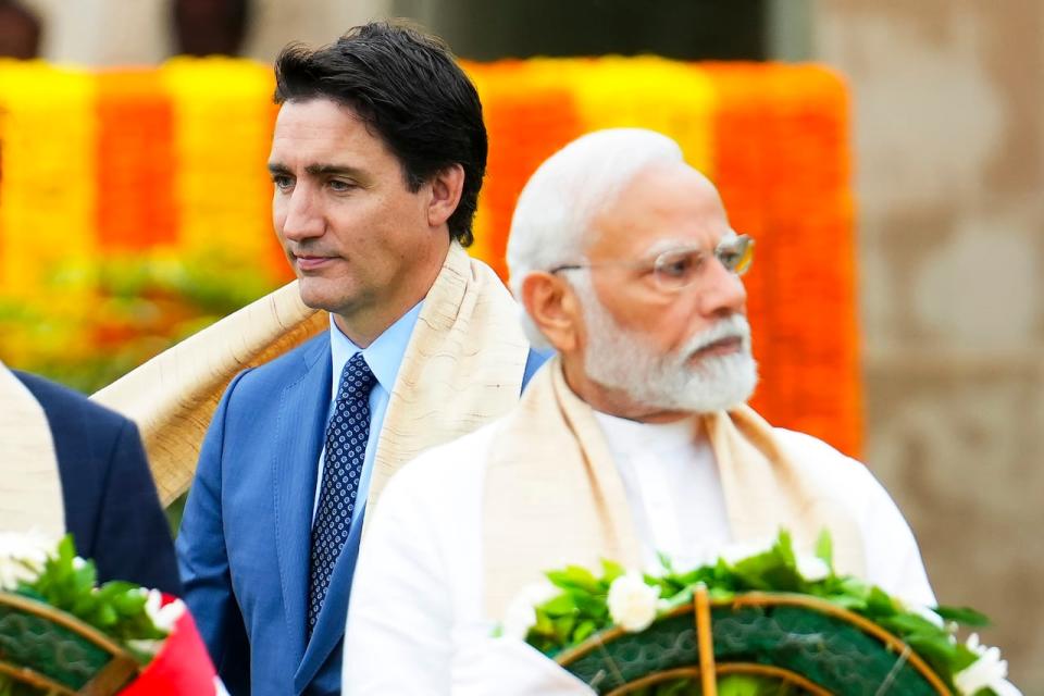 Prime Minister Justin Trudeau, left, walks past India's Prime Minister Narendra Modi as they take part in a wreath-laying ceremony at Raj Ghat, Mahatma Gandhi's cremation site, during the G20 Summit in New Delhi, Sunday, Sept. 10, 2023.