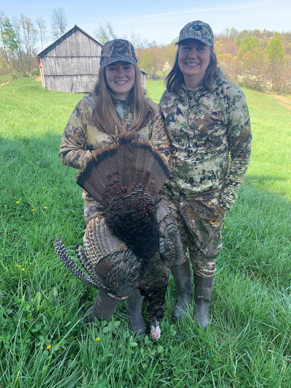 Sarah Schott, left, and her mother, Kelly, pose with a wild turkey harvested from the Schott family farm in Noble County.