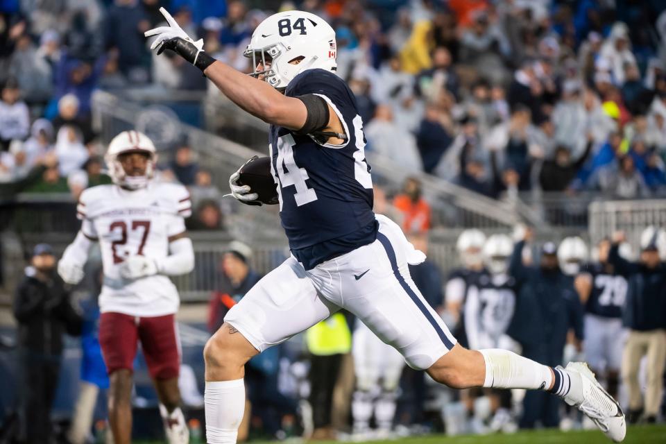 Penn State tight end Theo Johnson (84) celebrates as he scores a 30-yard receiving touchdown during the second half of a NCAA football game against Massachusetts Saturday, Oct. 14, 2023, in State College, Pa. The Nittany Lions won, 63-0.