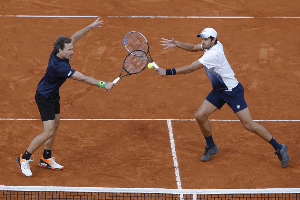 Croatia's Mate Pavic, right, and Brazil's Bruno Soares play a shot against Kevin Krawietz and Andreas Mies of Germany in the men's doubles final match of the French Open tennis tournament at the Roland Garros stadium in Paris, France, Saturday, Oct. 10, 2020. (AP Photo/Michel Euler)