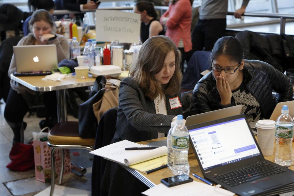 Volunteer lawyers work to help free travelers detained at John F. Kennedy International Airport in New York, Sunday, Jan. 29, 2017. As President Donald Trump’s order temporary banning refugees and citizens from seven Muslim-majority countries from traveling to the U.S.. dozens of attorneys descended on JFK., to advocate for people suddenly stuck in a limbo they argue is unjust and illegal. (AP Photo/Seth Wenig)