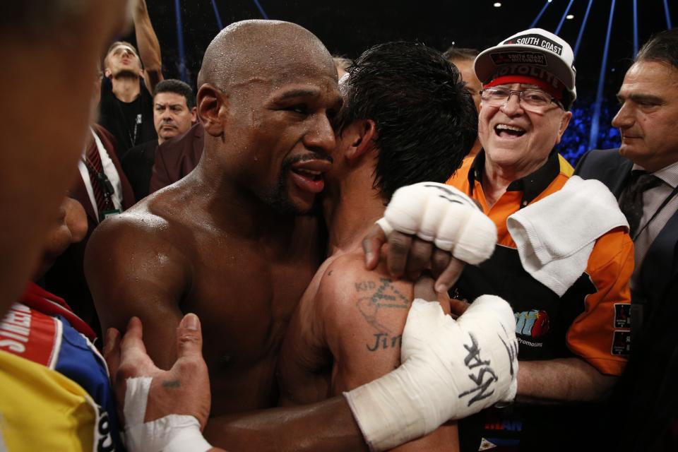 Floyd Mayweather and Manny Pacquiao embrace after their 2015 bout in Las Vegas. (Getty Images)