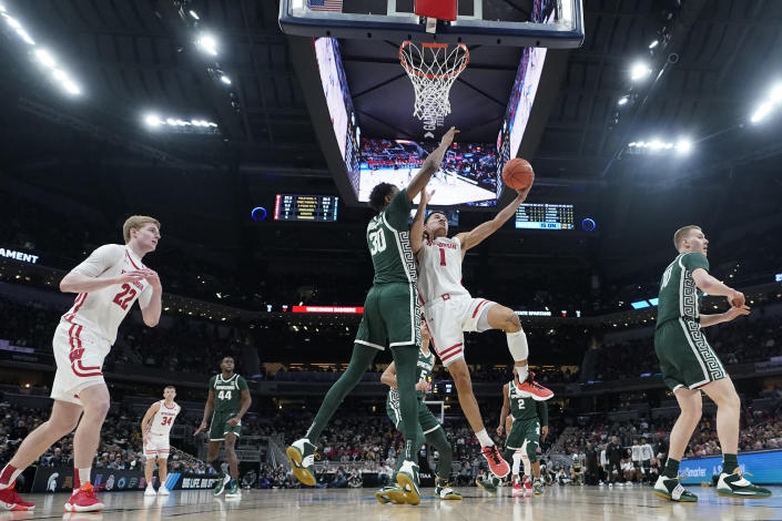 Wisconsin's Johnny Davis (1) shoots against Michigan State's Marcus Bingham Jr. (30) during the second half of an NCAA college basketball game at the Big Ten Conference men's tournament Friday, March 11, 2022, in Indianapolis. (AP Photo/Darron Cummings)