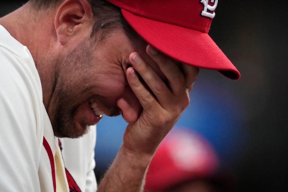 St. Louis Cardinals pitcher Adam Wainwright laughs as he watches from the dugout during the first inning of a baseball game against the Philadelphia Phillies Saturday, Sept. 16, 2023, in St. Louis. (AP Photo/Jeff Roberson)