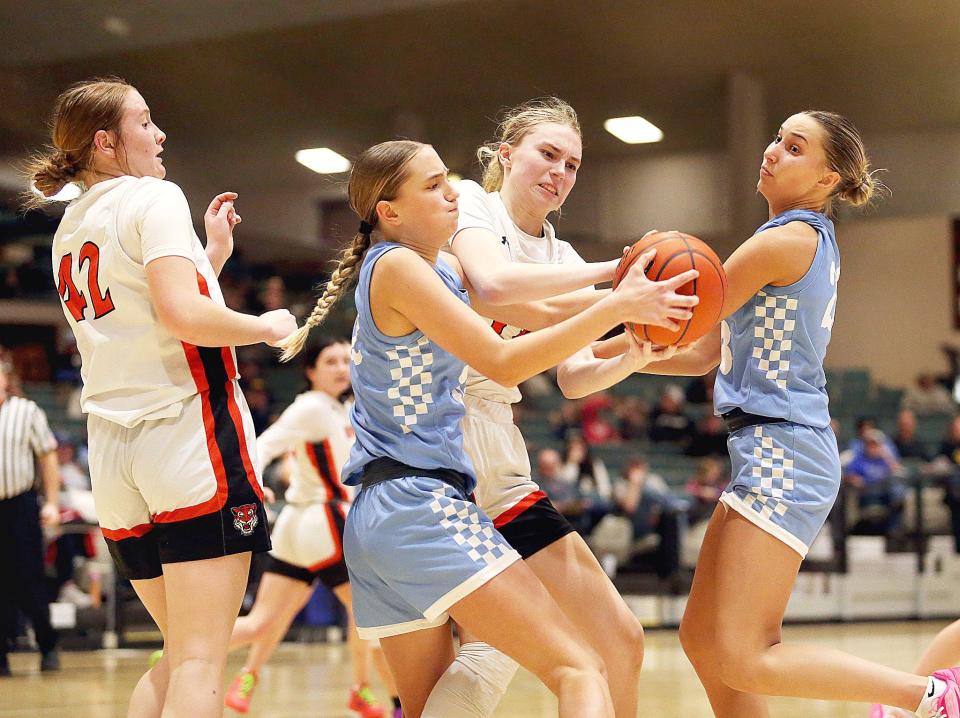 Hamlin’s Addelyn Jensen (32) battles with Howard’s Abby Aslesen (14) for a rebound during the second half of the Chargers’ 68-33 win over the Tigers in the DWU/Culver’s Classic on Friday, Feb. 9, 2024 at the Corn Palace in Mitchell. At right is Hamlin's Marissa Bawdon.