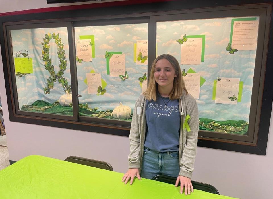 Katie Troxell, a senior at Conemaugh Township Area High School, stands in front of a display she created for a mental health conference she organized for her Gold Award project in Girl Scouting.