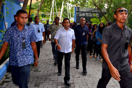 Maldives President Abdulla Yameen (C) arrives to cast his vote at a polling station during the presidential election in Male, Maldives September 23, 2018. President Media//Handout via REUTERS.