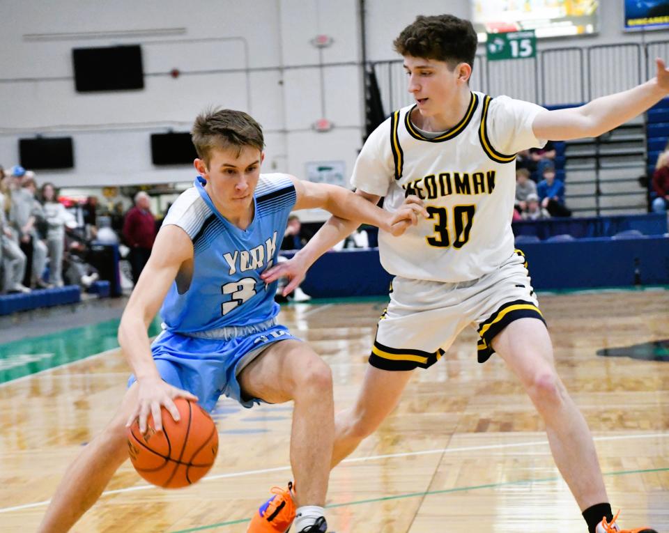 York freshman Reece MacDonald, left, tries to maneuver past Medomak Valley’s Kevin Sincyr during the Class B South quarterfinals Friday at the Portland Expo.