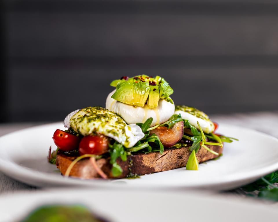 Burrata toast with poached eggs and avocado at Over Easy Kitchen, which has restaurants in Holmdel, Marlboro and Fair Haven.