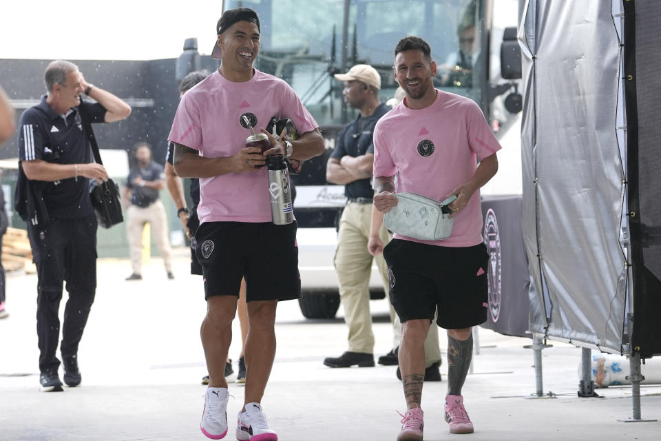 Inter Miami forward Luis Suarez, left, and forward Lionel Messi, right, arrive for an MLS soccer match against D.C. United, Saturday, May 18, 2024, in Fort Lauderdale, Fla. (AP Photo/Lynne Sladky)