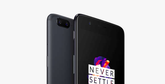 A close up of two OnePlus 5 devices shown with one facing backward and one facing forward with the words never settle on the screen.