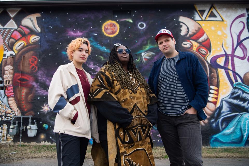 Bexx Chin, Elisheba Israel Mrozik and Robert Jones stand outside One Drop Ink Tattoo Parlour in Nashville, Tenn., Friday, Dec. 29, 2023. Mrozik founded the tattoo parlor and painted the mural on its side. She is also the president of North Nashville Arts Coalition. Jones and Chin work at Overton Arts at the 100 Taylor Arts Collective. Metro Arts reduced funding for the coalition and collective this year.