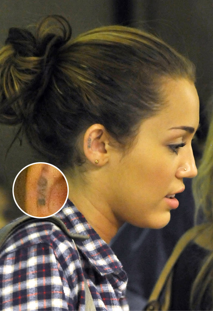 Forget wearing your heart on your sleeve -- Miley Cyrus wears it on her ear. The former Disney star got the word "Love" scrawled on the inside of her ear in June 2010 when she was dating now-fiance Liam Hemsworth. It's not just the placement of the tattoo that's bad, but it also looks like one of her friends just did it themselves.