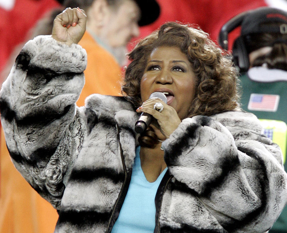 <p>Aretha Franklin wears a grey and black striped fur coat while performing the national anthem before the Super Bowl XL football game between the Pittsburgh Steelers and Seattle Seahawks in Detroit, Mich. (AP Photo/Michael Conro </p>