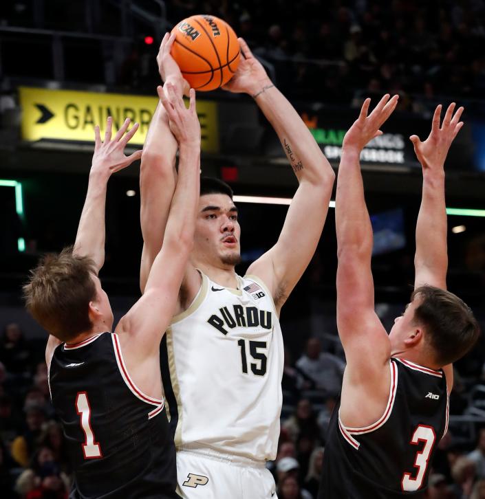Davidson Wildcats guard Reed Bailey (1) and Davidson Wildcats forward Sam Mennenga (3) defend Purdue Boilermakers center Zach Edey (15) during the Indy Classic NCAA men’s basketball doubleheader, Saturday, Dec. 17, 2022, at Gainbridge Fieldhouse in Indianapolis. Purdue won 69-61.