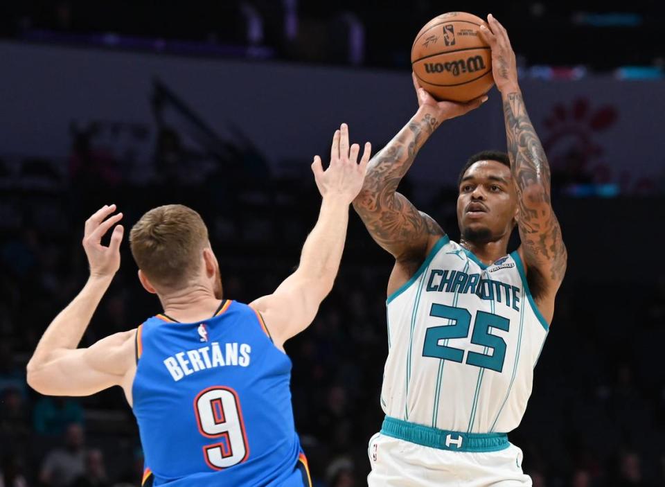 Charlotte Hornets forward P.J. Washington, right, releases a jump shot over Oklahoma City Thunder forward Davis Bertans, left, during first half action on Sunday, October 15, 2023 at Spectrum Center in Charlotte, NC.
