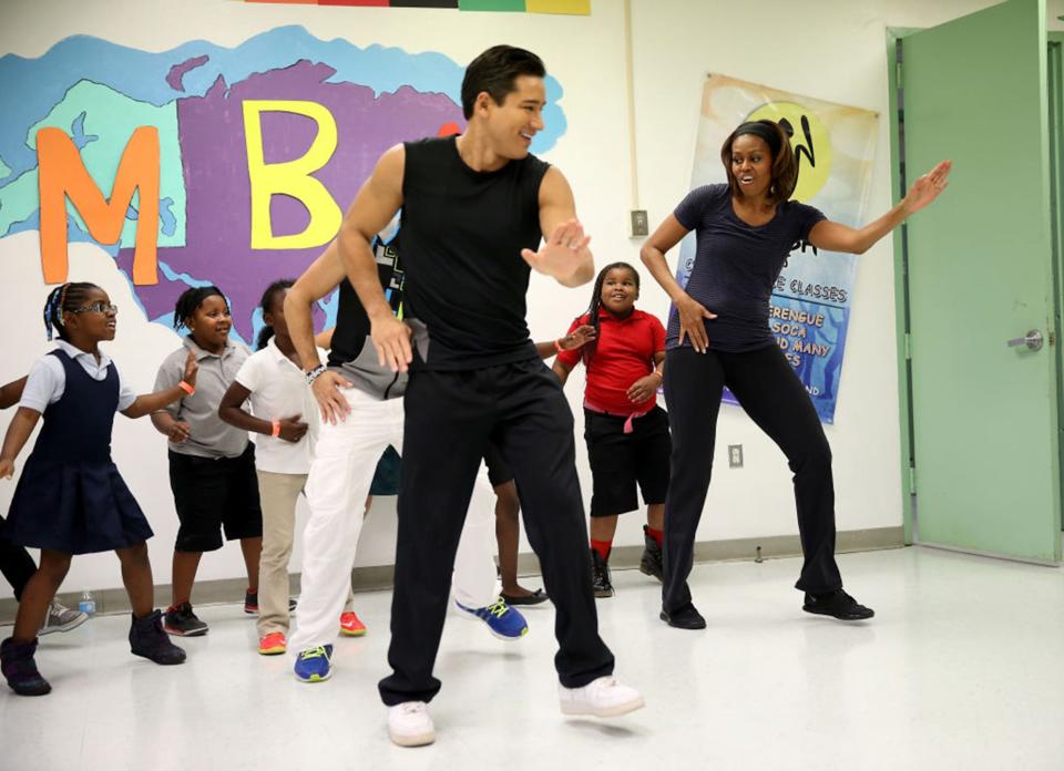 First Lady Michelle Obama, right, dances in a Zumba class along with children and actor Mario Lopez, center, during a visit to the Gwen Cherry Park NFL/YET Center on Feb. 25, 2014, in Miami, Florida. The visit was part of a celebration around the fourth anniversary of “Lets Move!,” her initiative to ensure that all our children grow up healthy and reach their full potential. (Joe Raedle / Getty Images)