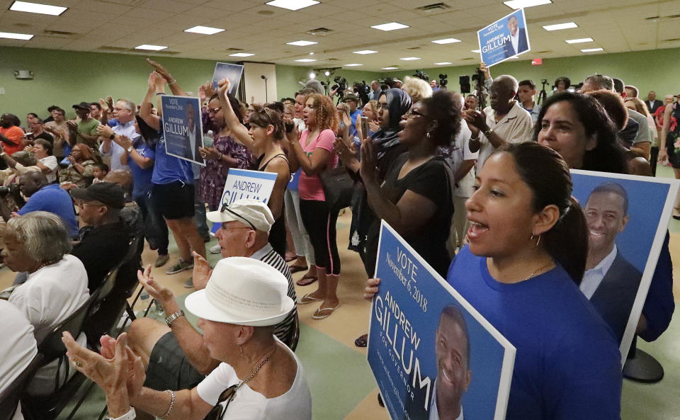 Supporters clap and cheer during a campaign rally for Florida Democratic gubernatorial candidate Andrew Gillum after he was endorsed by Puerto Rico Governor Ricardo Rossello Monday Oct. 1, 2018, in Kissimmee, Fla. (AP Photo/John Raoux)