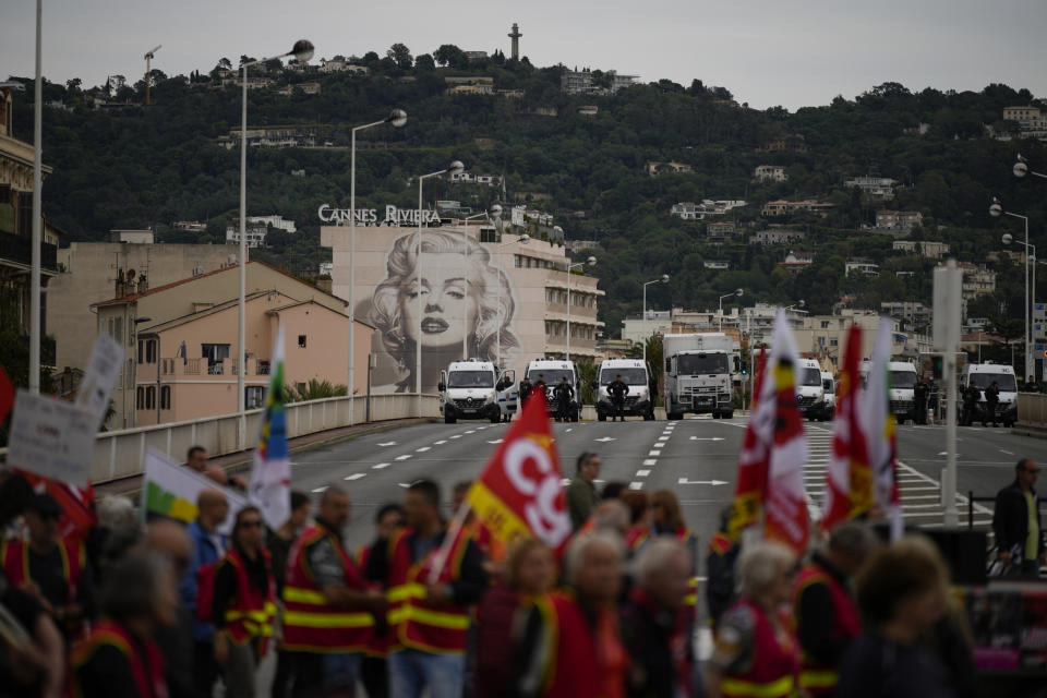 French union demonstrators protest President Emmanuel Macron's pension reform during the 76th edition of the Cannes Film Festival in Cannes, Sunday, May 21, 2023. (AP Photo/Daniel Cole)