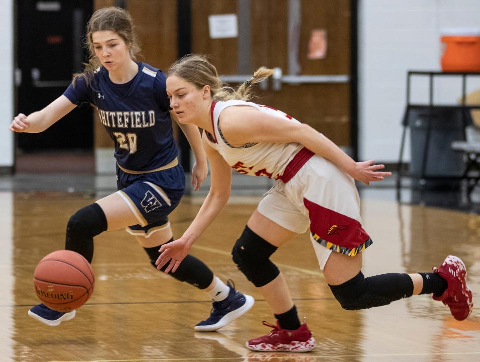 Bulllitt East's Lilly Reid, right, loses control fo the ball while being defended by Whitefield Academy's Sara Ritter during 24th District Girls tournament action. Feb. 21, 2022