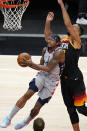 Washington Wizards guard Bradley Beal, left, goes to the basket as Utah Jazz center Rudy Gobert, right, defends in the first half during an NBA basketball game Monday, April 12, 2021, in Salt Lake City. (AP Photo/Rick Bowmer)