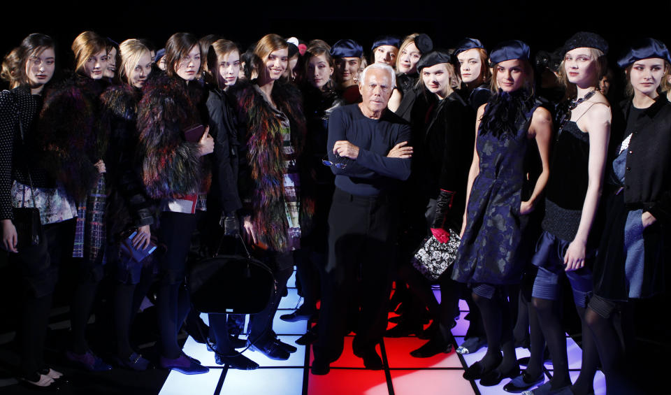 Italian fashion designer Giorgio Armani poses with his models at the end of the Emporio Armani women's Fall-Winter 2012-2013 collection that was presented in Milan, Italy, Saturday, Feb. 25, 2012.(AP Photo/Luca Bruno)