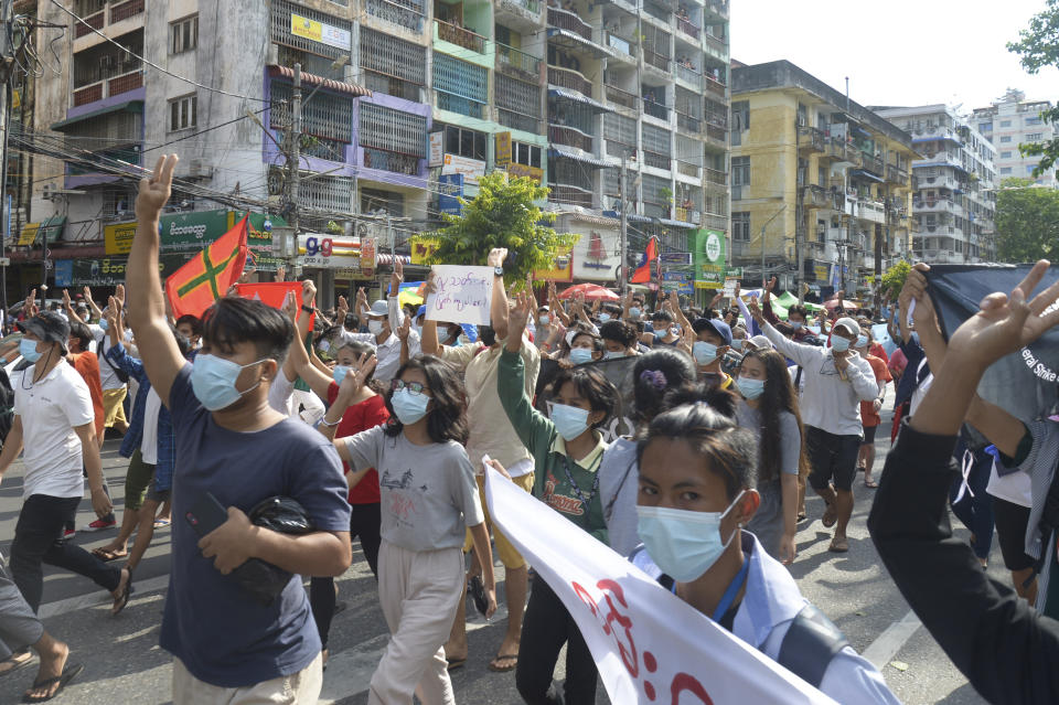 Anti-coup protesters flash the three-finger salute of defiance during a demonstration on Thursday, May 6, 2021, in Yangon, Myanmar. More than 200 global organizations urged the U.N. Security Council on Wednesday, May 5, 2021, to impose an arms embargo on Myanmar, saying the time for statements has passed and immediate action is needed to help protect peaceful protesters against military rule and other opponents of the junta. (AP Photo)