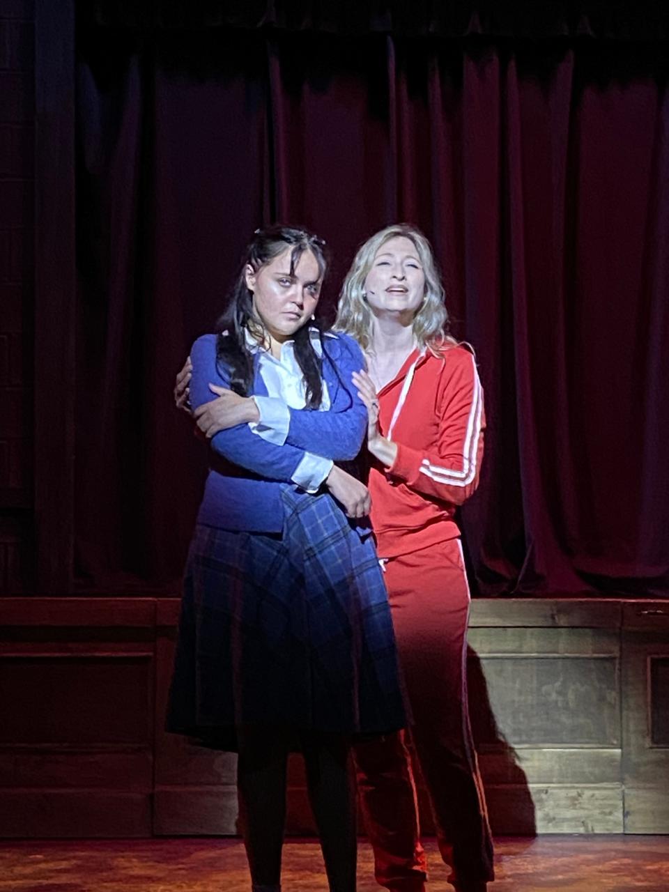 Carrie (Keeley Pendergrass) is comforted by her supportive teacher, Miss Gardener (Jennifer Wingerter) in "Carrie: The Musical" at TheatreZone in Naples, Florida.