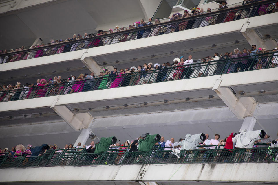 Dozens of fans and TV cameras line the grandstand at Churchill Downs.