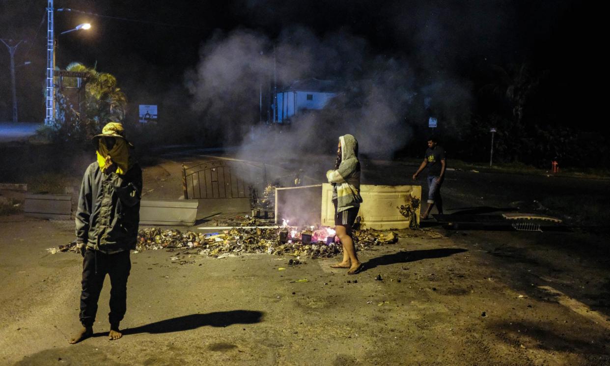 <span>A fire burns at a roadblock in the district of Auteuil, outside Noumea, in New Caledonia on 19 June, after independence activists were sent to France for pre-detention.</span><span>Photograph: Thomas Bernardi/AFP/Getty Images</span>
