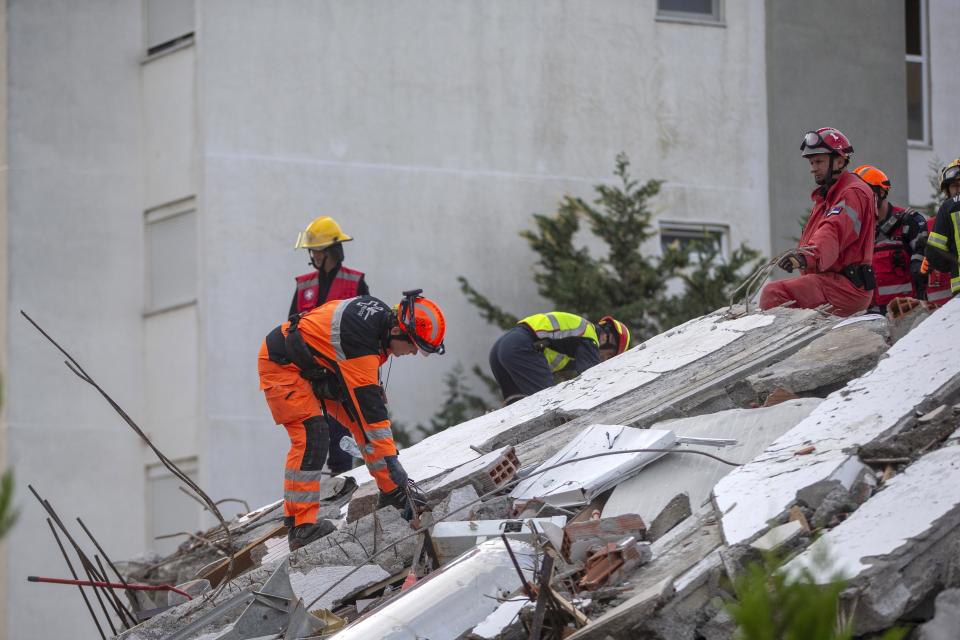 In this photo taken on Friday, Nov. 29, 2019, rescuers from France and Switzerland operate at a collapsed building after the 6.4-magnitude earthquake in Durres, western Albania. In the initial hours after a deadly pre-dawn earthquake struck Albania, pancaking buildings and trapping dozens of sleeping people beneath the rubble, the country’s neighbors sprang into action. Offers of help flooded in from across Europe and beyond, with even traditional foes setting aside their differences in the face of the natural disaster. The 6.4-magnitude earthquake that struck Albania on Tuesday killed at least 49 people, injured 2,000 and left at least 4,000 homeless. (AP Photo/Visar Kryeziu)