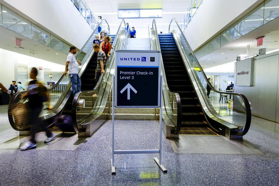 People walk at the United Airlines terminal at the Newark Liberty International Airport in New Jersey, July 8, 2015. (Reuters)