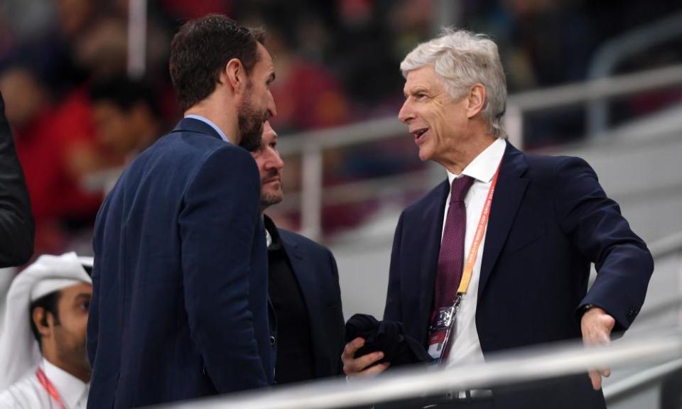 Gareth Southgate (left) talks to FIFA’s global football development Arsène Wenger (right) at a Club World Match match in Qatar.