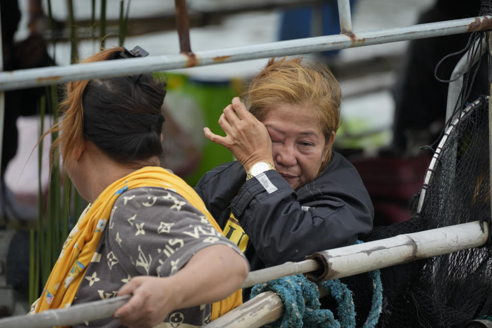 A family member grieves as they transfer the coffin of one of the victims of a passenger boat that capsized in Binangonan, Rizal province, Philippines on Friday, July 28, 2023. A small Philippine ferry turned upside down when passengers suddenly crowded to one side in panic as fierce winds pummeled the wooden vessel, leaving scores of people dead while others were rescued, officials said Friday. (AP Photo/Aaron Favila)