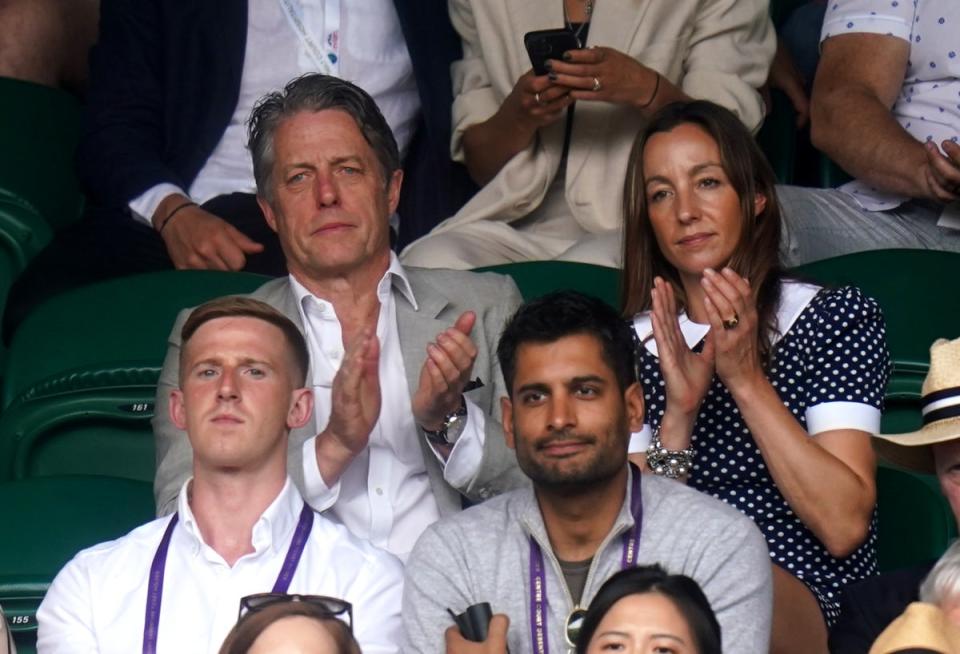 Hugh Grant and Anna Elisabet Eberstein clapped along as they watch the action from the sidelines (Adam Davy/PA) (PA Wire)