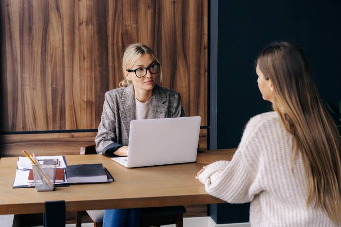 two employees talking at a table