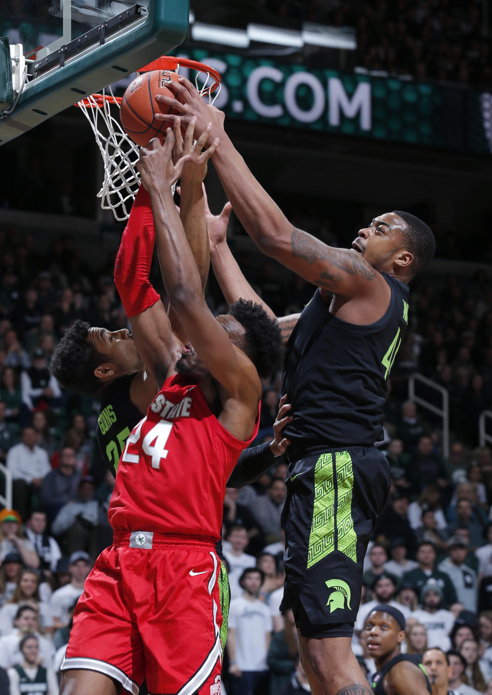 Michigan State's Nick Ward, right, and Kenny Goins, left, and Ohio State's Andre Wesson, center, battle for a rebound during the first half of an NCAA college basketball game, Sunday, Feb. 17, 2019, in East Lansing, Mich. (AP Photo/Al Goldis)